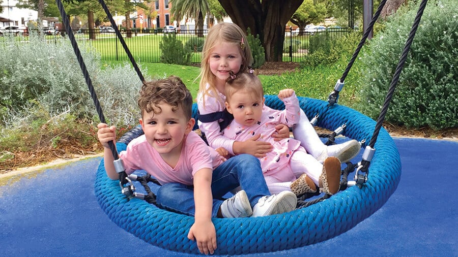 Friends Brady, Summer and Luca having fun on the swing